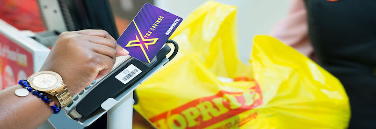 a customer swiping their shoprite xtra savings card at a shoprite tillpoint