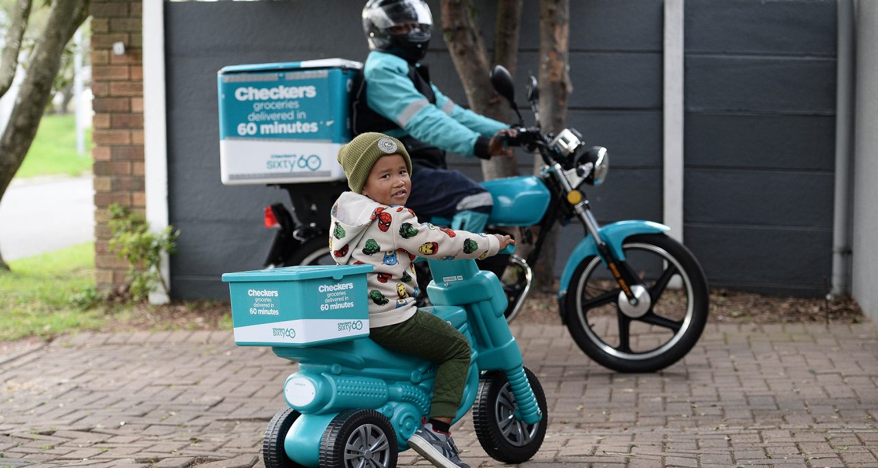 A little boy on a small teal Sixt60 bike.