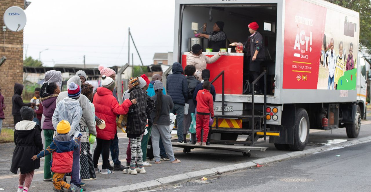 A Shoprite soup truck serving people warm meals.