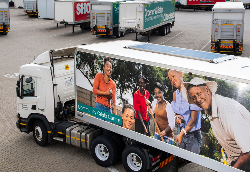A Shoprite truck with an image of a small community on the trailer.