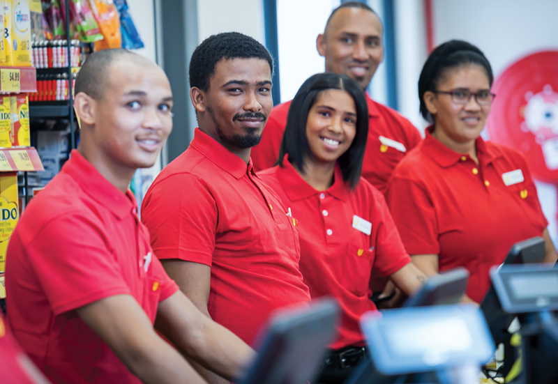 A group of Usave cashiers standing behind their till points.